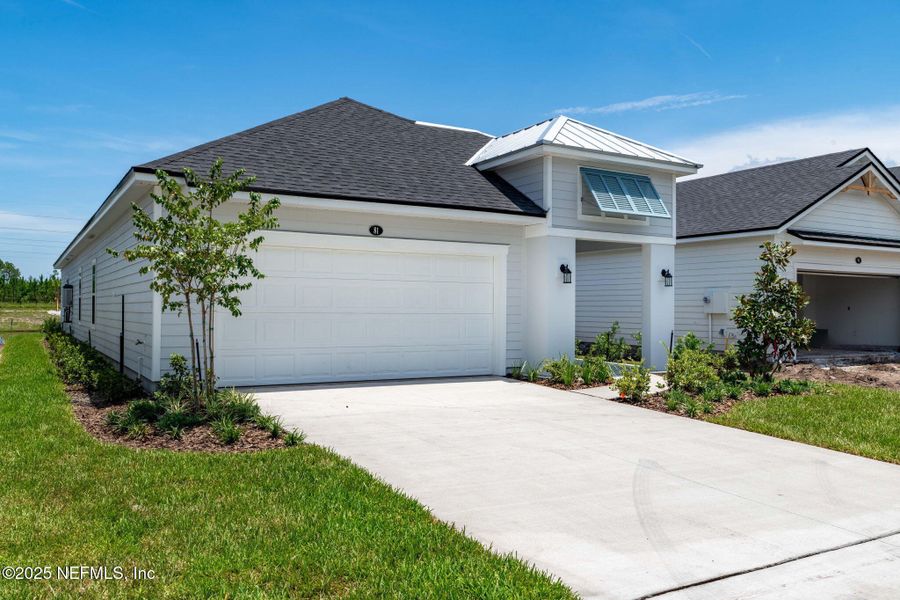 Front exterior of a new home in Beacon Lake, St. Augustine, FL, highlighting curb appeal (Image 36).
