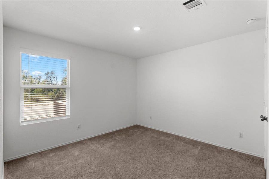 Carpeted empty room featuring baseboards