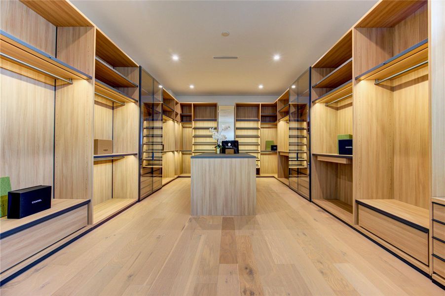 Couture-inspired primary wardrobe with custom cabinetry and center island.