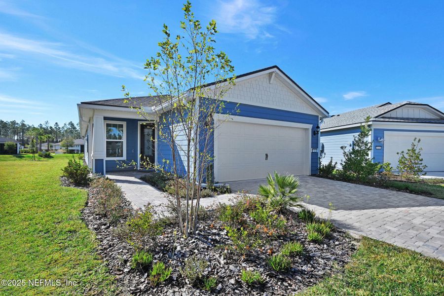 Front exterior of a new home in Del Webb Wildlight, Wildlight, FL, highlighting curb appeal (Image 1). Front exterior of a new home in Del Webb Wildlight, Wildlight, FL, highlighting curb appeal (Image 1).
