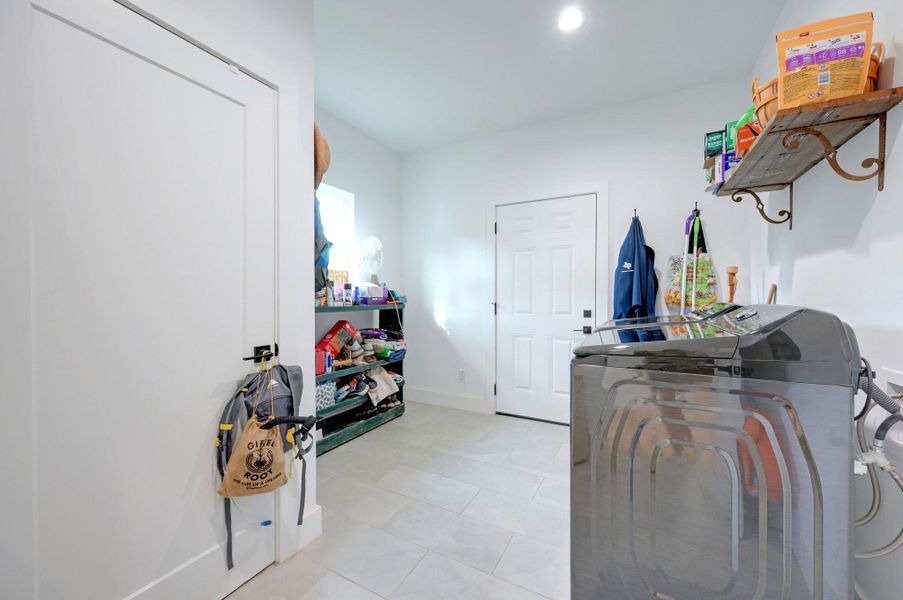 Laundry room with additional storage space.