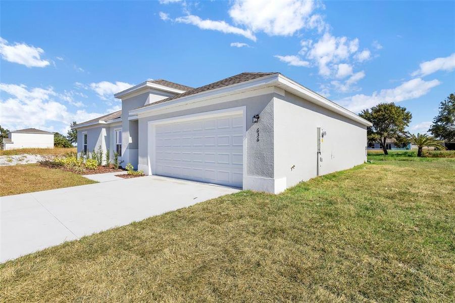 Front exterior of a new home in Grand Oaks, Avon Park, FL, highlighting curb appeal (Image 8).