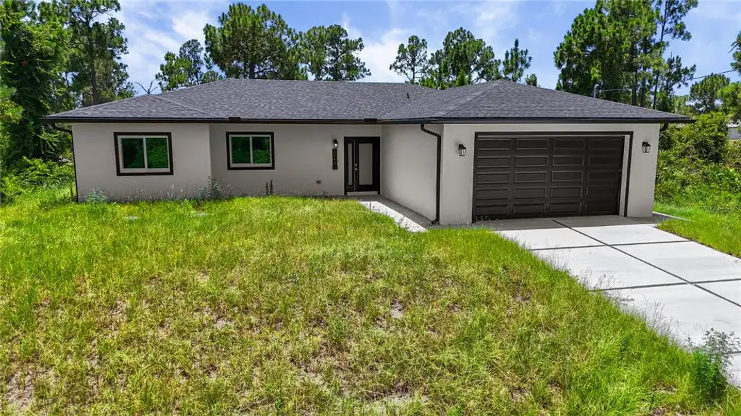 Front exterior of a new home in , Lehigh Acres, FL, highlighting curb appeal (Image 2). Front exterior of a new home in , Lehigh Acres, FL, highlighting curb appeal (Image 2).