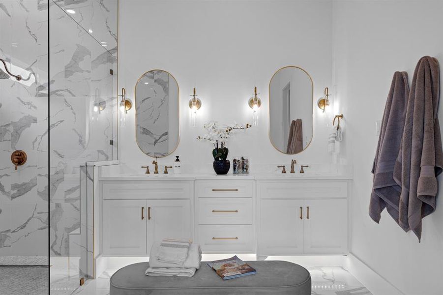 Full bath featuring double vanity, a marble finish double shower, and marble finish flooring with decorative lighting throughout Full bath featuring double vanity, a marble finish double shower, and marble finish flooring with decorative lighting throughout