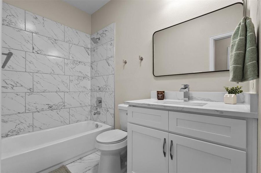 Full bathroom with shower / washtub combination, light marble finish floors, and vanity Full bathroom with shower / washtub combination, light marble finish floors, and vanity