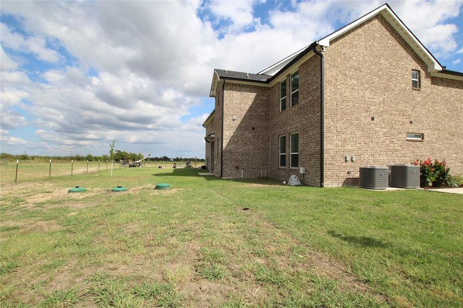 View of side of home with brick siding and a view of rural / pastoral area View of side of home with brick siding and a view of rural / pastoral area