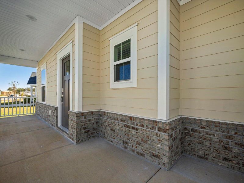 Exterior details and patio area of a home in The Coves at Lakes of Cane Bay II, Summerville (Image 3).