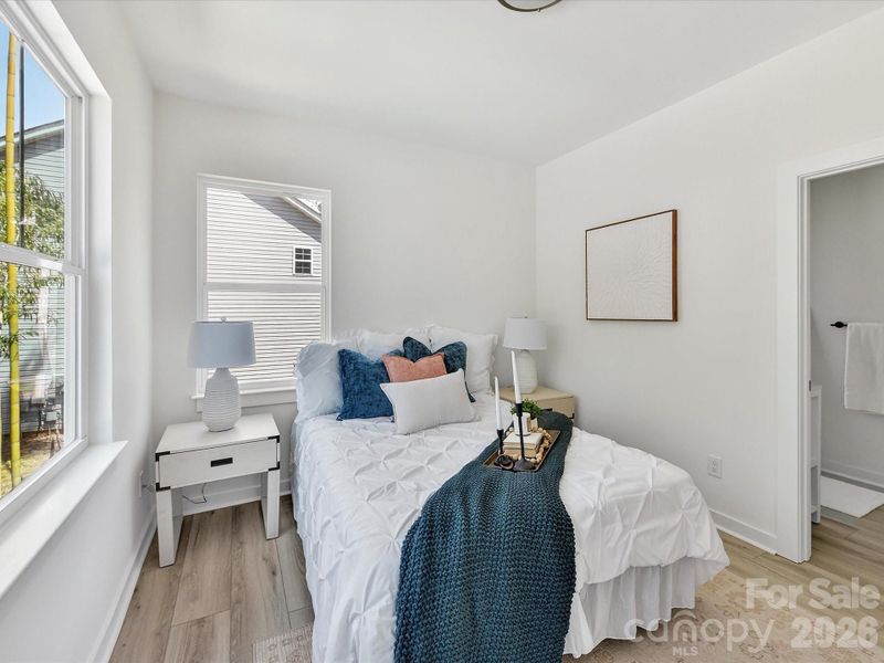 Bright and airy primary suite featuring a spacious bedroom, modern ensuite bathroom with sleek finishes, and a large walk-in closet for ample storage.