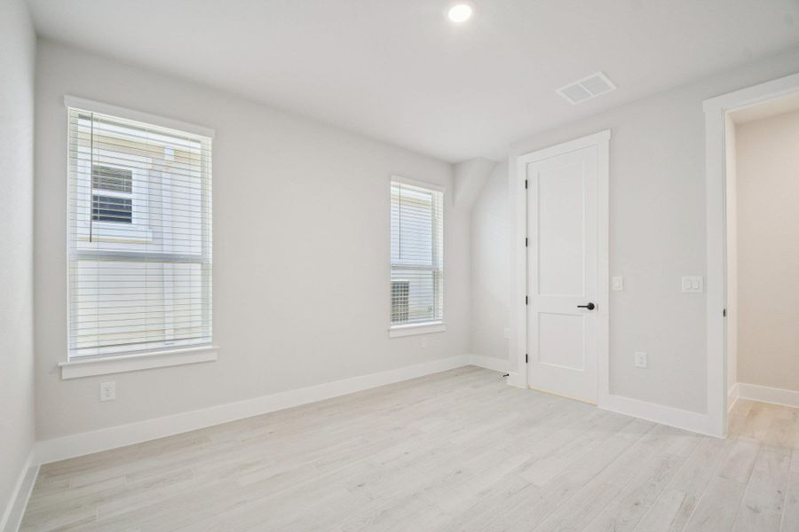 Unfurnished bedroom with light wood-style flooring and recessed lighting