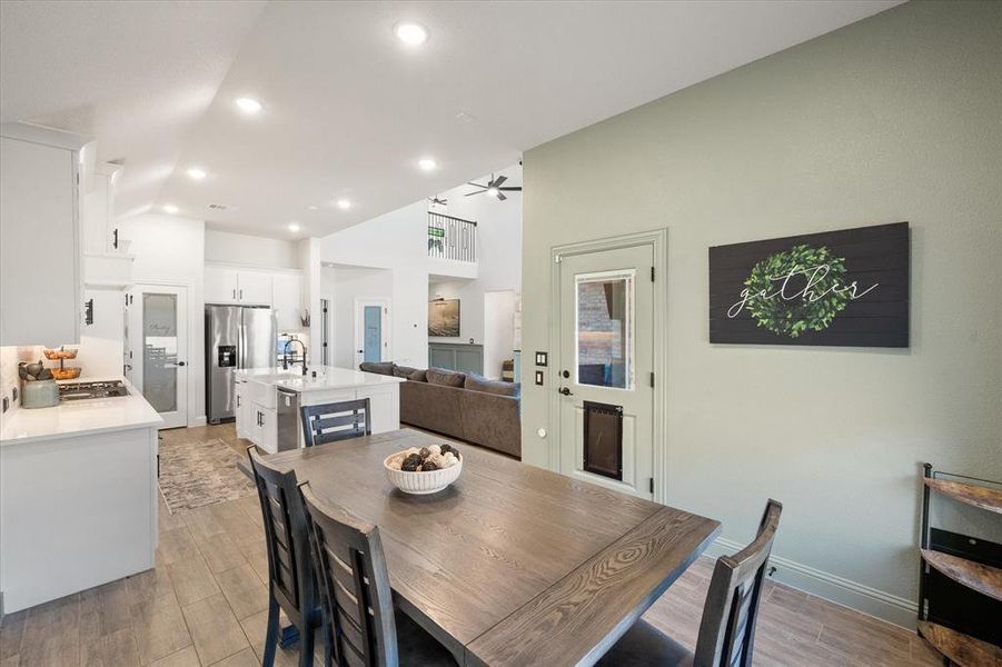 Dining area with light wood-style flooring, recessed lighting, and ceiling fan
