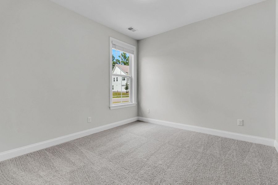 Spacious, unfurnished interior of a new home in Tidewater at Lakes of Cane Bay, Summerville (Image 20).