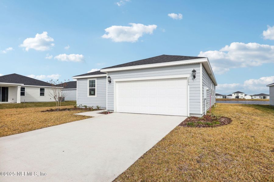 Front exterior of a new home in Lakes at Bella Lago - Signature Series, Green Cove Springs, FL, highlighting curb appeal (Image 19).