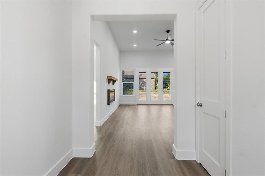 Spacious interior featuring wood-finish flooring, white walls, and recessed lighting