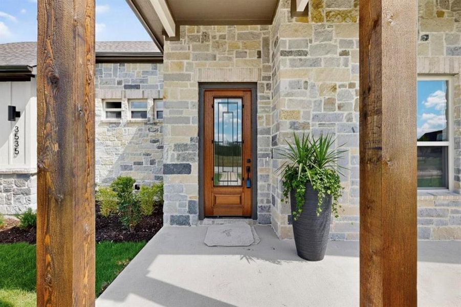 View of exterior entry featuring stone siding