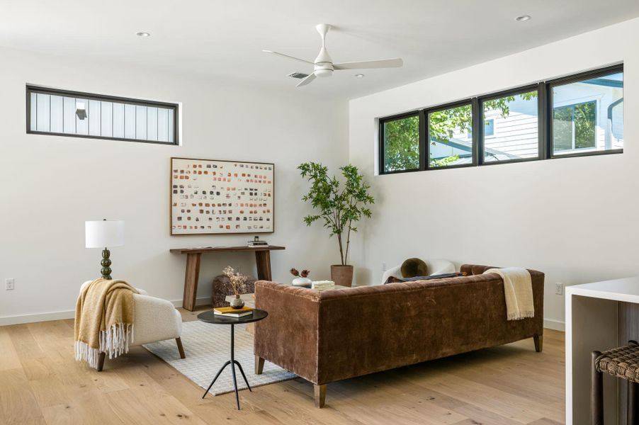High ceilings and warm wood floors define this bright living space with clerestory windows.