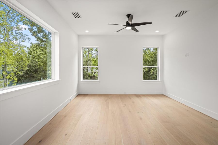 Upstairs, a spacious secondary bedroom measuring 19x14 showcases stunning white oak floors, abundant natural light, and a generous walk-in closet for effortless storage. Upstairs, a spacious secondary bedroom measuring 19x14 showcases stunning white oak floors, abundant natural light, and a generous walk-in closet for effortless storage.