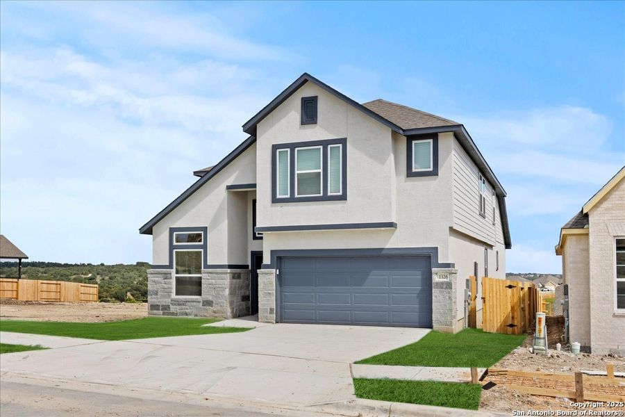 Front exterior of a new home in Meyer Ranch, New Braunfels, TX, highlighting curb appeal (Image 1).