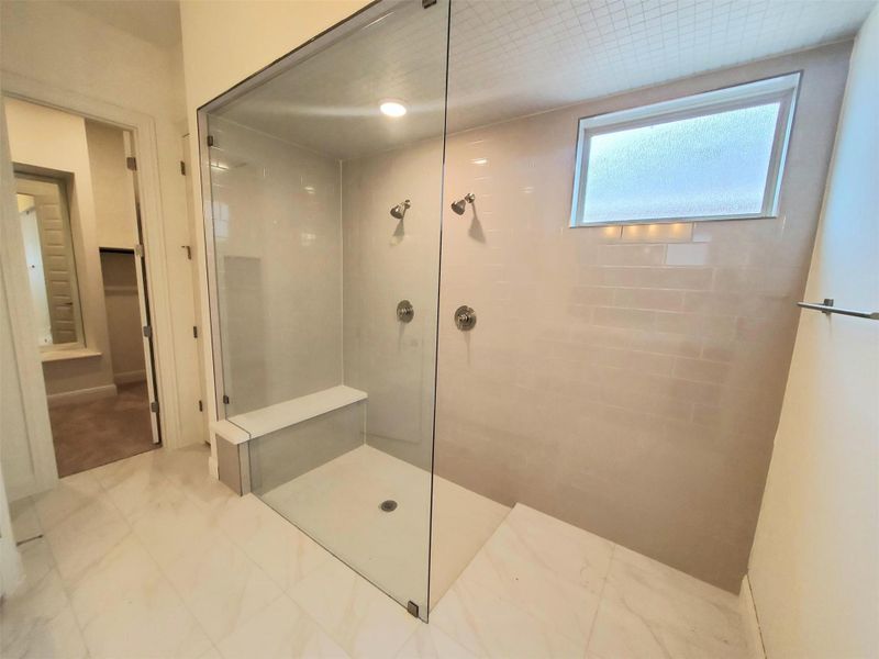Full bath featuring walk in shower and marble finish floor Full bath featuring walk in shower and marble finish floor