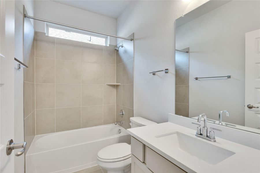 Bathroom with shower / washtub combination, vanity, and tile patterned floors Bathroom with shower / washtub combination, vanity, and tile patterned floors