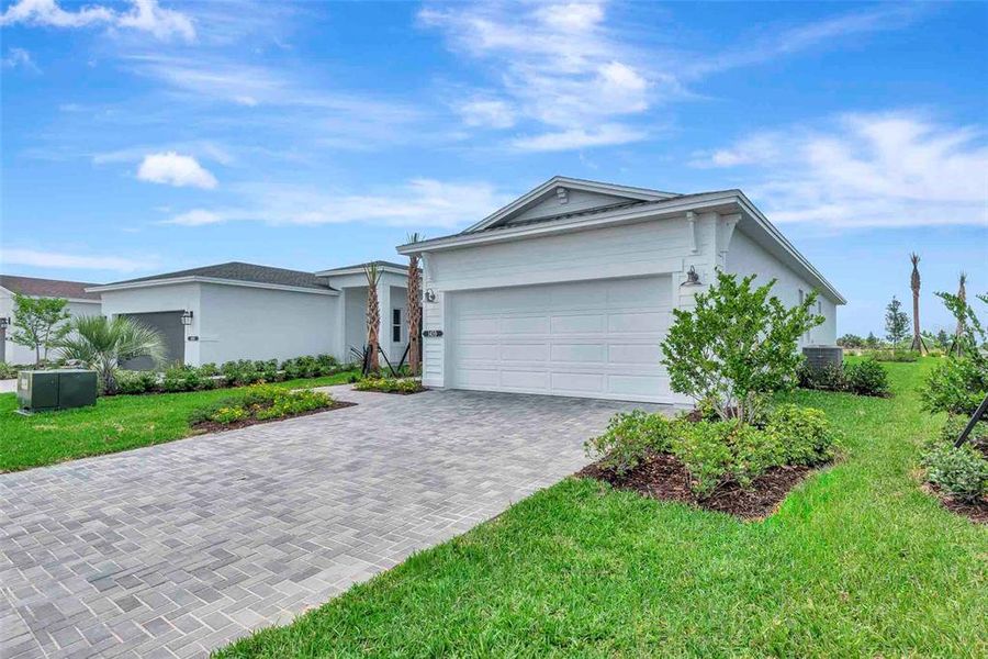 Front exterior of a new home in Cresswind at Lake Harris, Tavares, FL, highlighting curb appeal (Image 25).