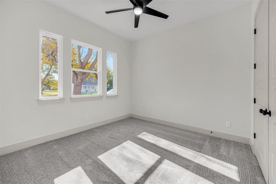 Spare room with light carpet and ceiling fan