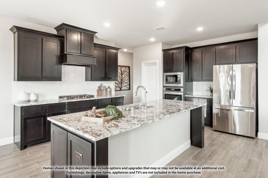Kitchen with dark cabinets, granite island, stainless steel appliances, and wood-look tile floors Kitchen with dark cabinets, granite island, stainless steel appliances, and wood-look tile floors