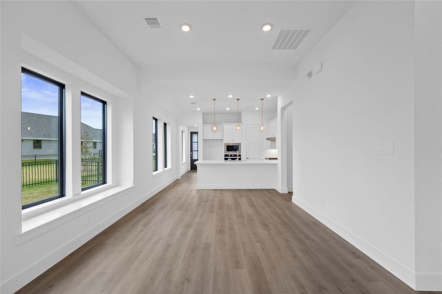 Create lasting memories around the table with family and friends in the dining! It showcases high ceilings, large windows, laminate flooring, and recessed lighting for a warm and welcoming atmosphere.