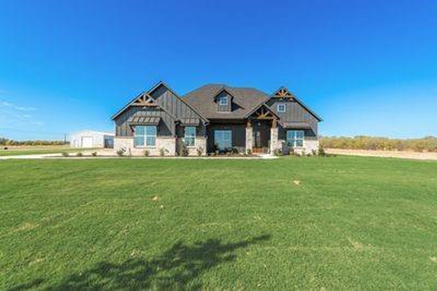 Craftsman-style home featuring a front yard