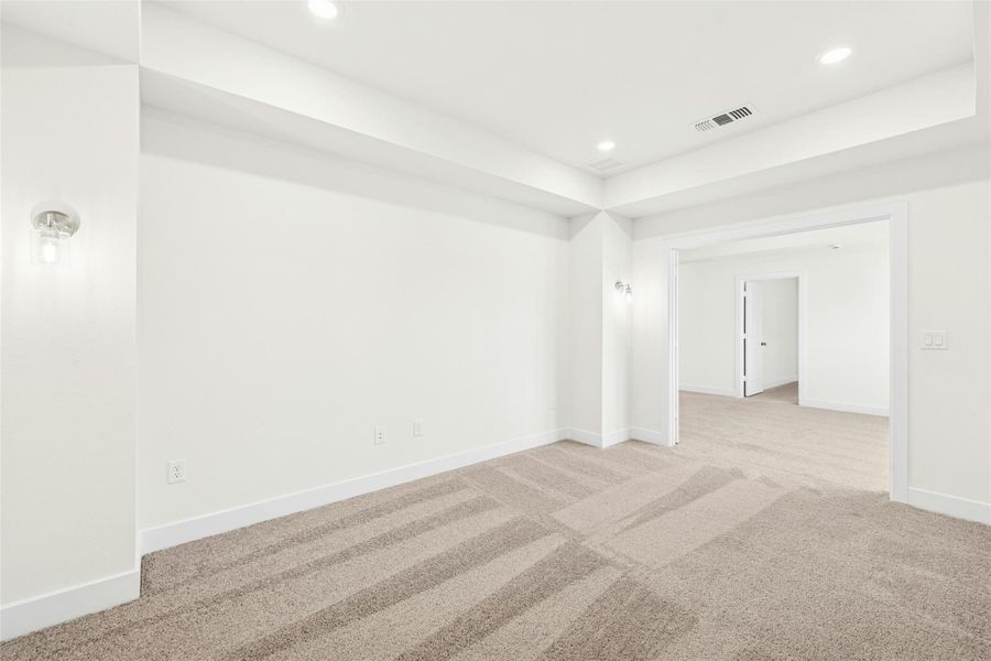 Carpeted empty room featuring recessed lighting