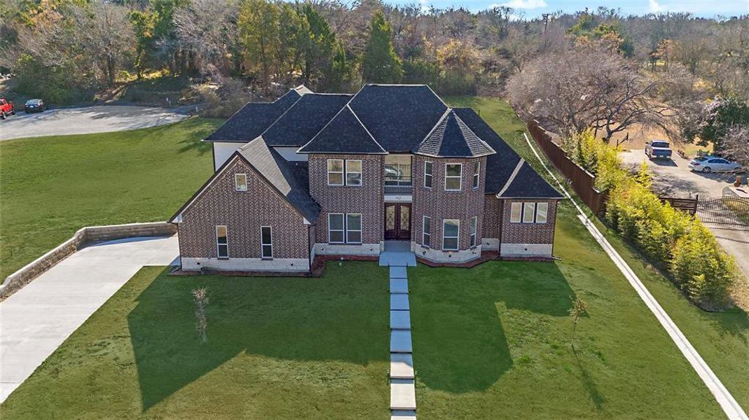 View of front facade with brick siding, driveway, and roof with shingles View of front facade with brick siding, driveway, and roof with shingles