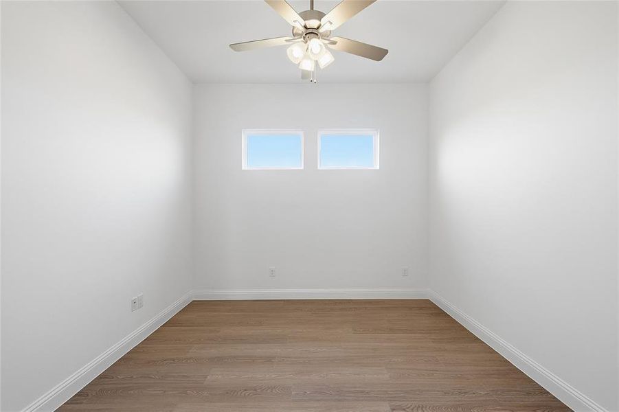 Unfurnished room with light wood finished floors and a ceiling fan
