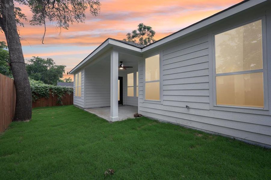 Rear view of property featuring a ceiling fan and a patio area Rear view of property featuring a ceiling fan and a patio area
