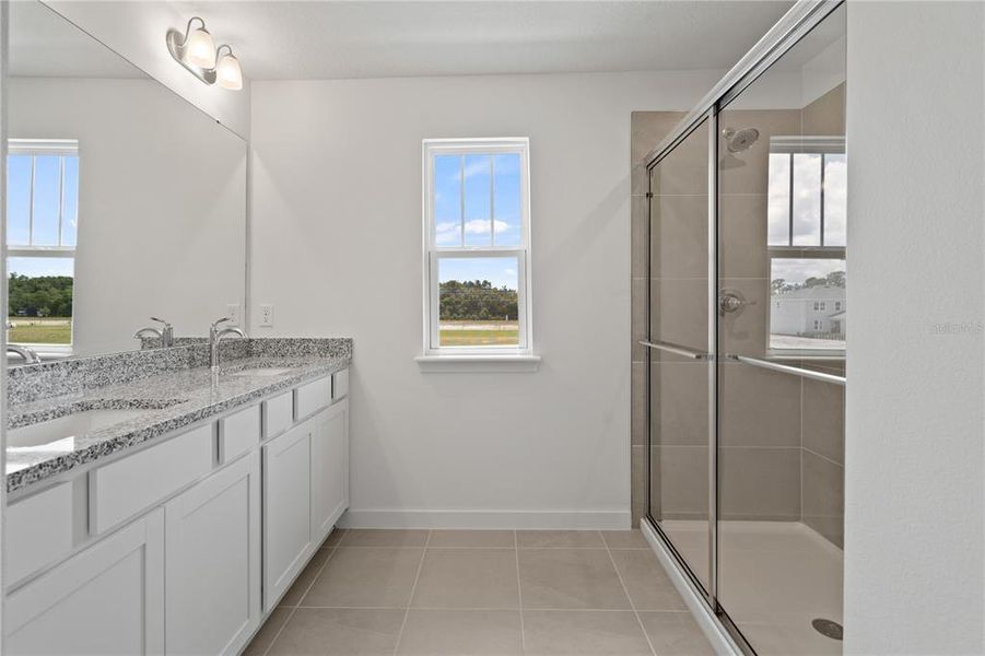 Primary bathroom with double vanity and lots of light.