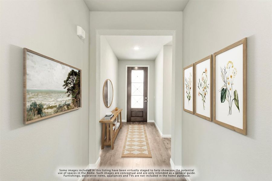 Entryway hallway with wood floors, framed wall art, console table, and glass-panel front door Entryway hallway with wood floors, framed wall art, console table, and glass-panel front door