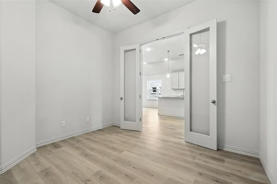 Unfurnished room with ceiling fan and light wood-style floors Unfurnished room with ceiling fan and light wood-style floors