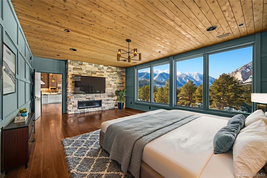 Virtually staged primary bedroom with gas fireplace and blackout remote controlled shades Virtually staged primary bedroom with gas fireplace and blackout remote controlled shades