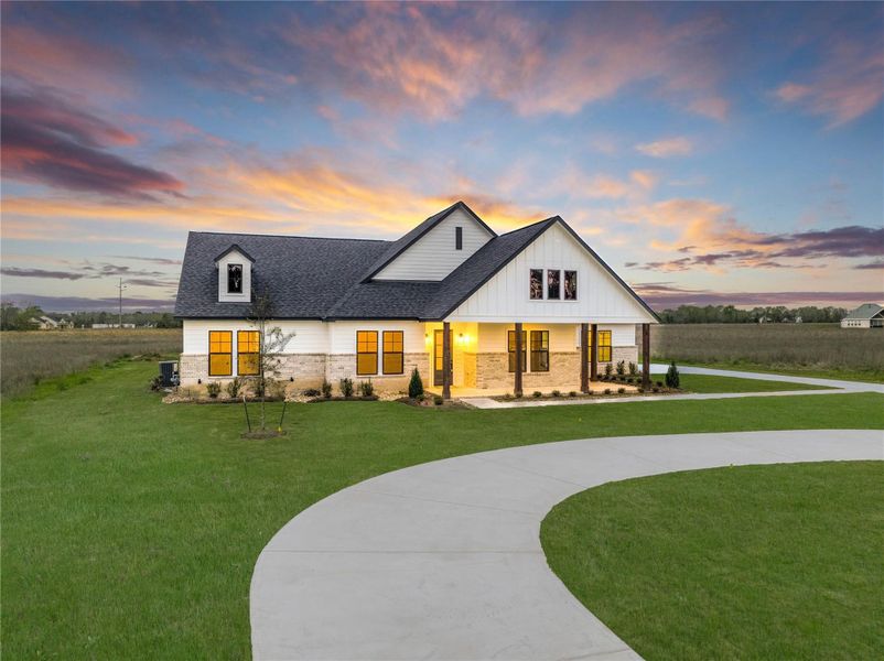 Front exterior of a new home in High Meadow Estates, New Waverly, TX, highlighting curb appeal (Image 24).