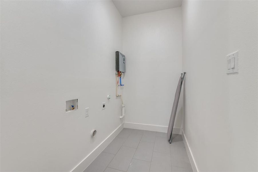 Laundry room featuring hookup for a washer and dryer, light tile patterned floors