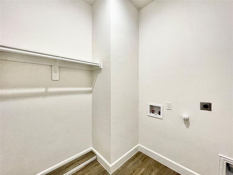Laundry room with dark wood-style flooring, laundry area, gas dryer hookup, hookup for an electric dryer, and hookup for a washing machine
