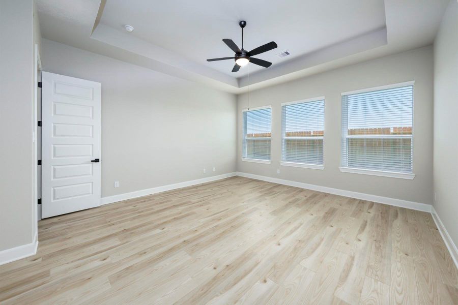 The spacious primary bedroom has beautiful ceilings and hardwood flooring. The spacious primary bedroom has beautiful ceilings and hardwood flooring.