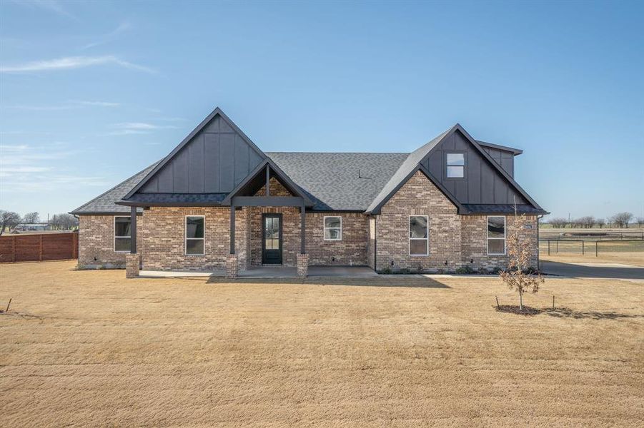 View of front facade featuring a patio and a front yard