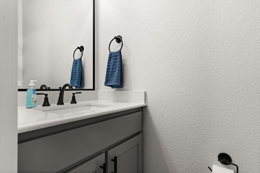 Bathroom with a textured wall and vanity Bathroom with a textured wall and vanity