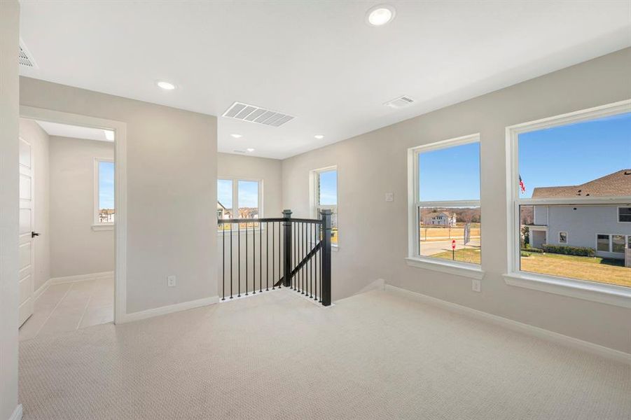 Spare room featuring light carpet and recessed lighting