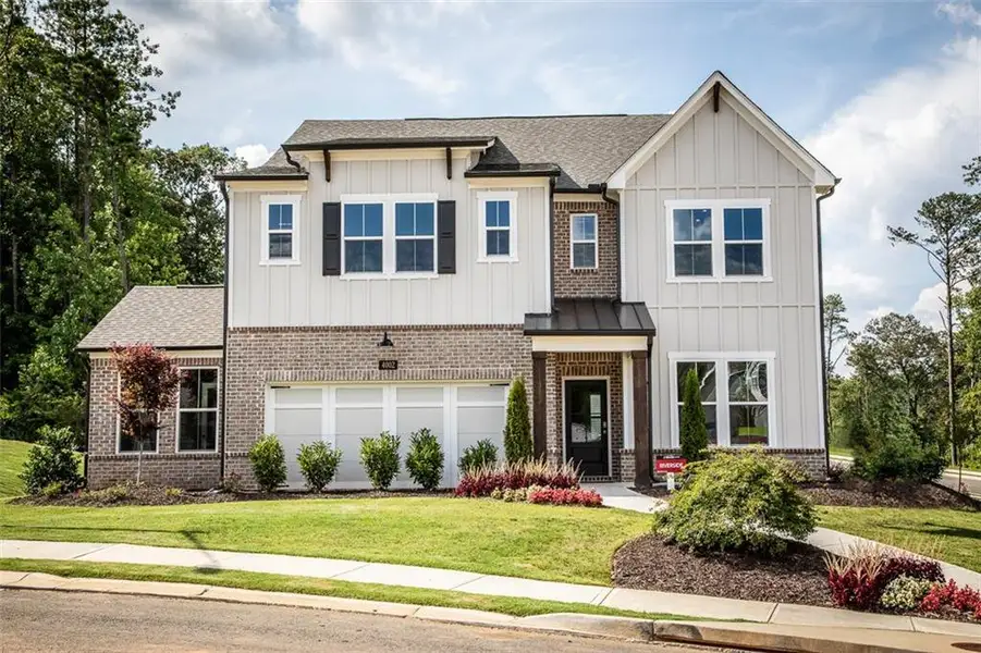 Front exterior of a new home in Hopewell Reserve, Cumming, GA, highlighting curb appeal (Image 2). Front exterior of a new home in Hopewell Reserve, Cumming, GA, highlighting curb appeal (Image 2).