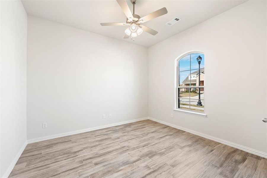 Unfurnished room with wood finished floors and ceiling fan