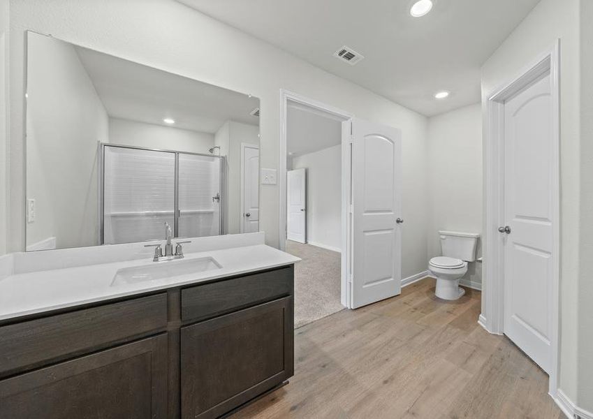 The master bathroom of the Cedar has a vanity with plenty of counterspace.