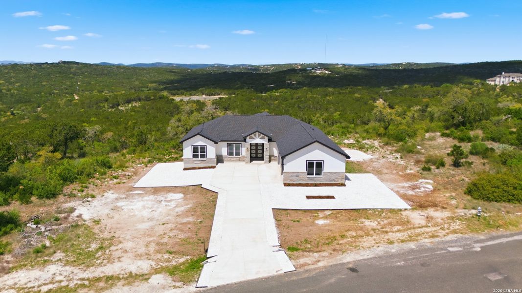 Front exterior of a new home in , Mico, TX, highlighting curb appeal (Image 7).
