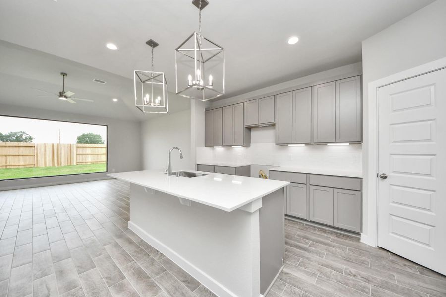 All of this overlooks your expansive family room, creating a perfect space for culinary delights and family gatherings. Sample photo of completed home with similar floor plan. Actual colors and selections may vary.