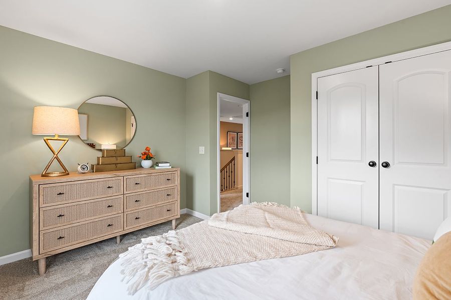 A bedroom with a bed and dresser. A bedroom with a bed and dresser.