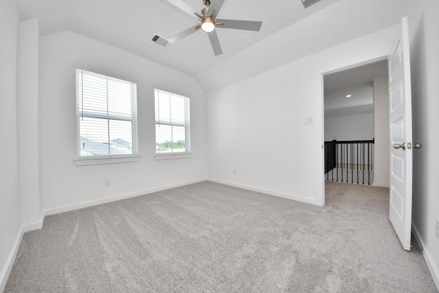 Generously sized secondary bedrooms featuring spacious closets, soft and inviting carpeting underfoot, large windows allowing plenty of natural light, and the added touch of privacy blinds for your personal retreat. Sample photo of completed home with similar floor plan. Actual colors and selections may vary.